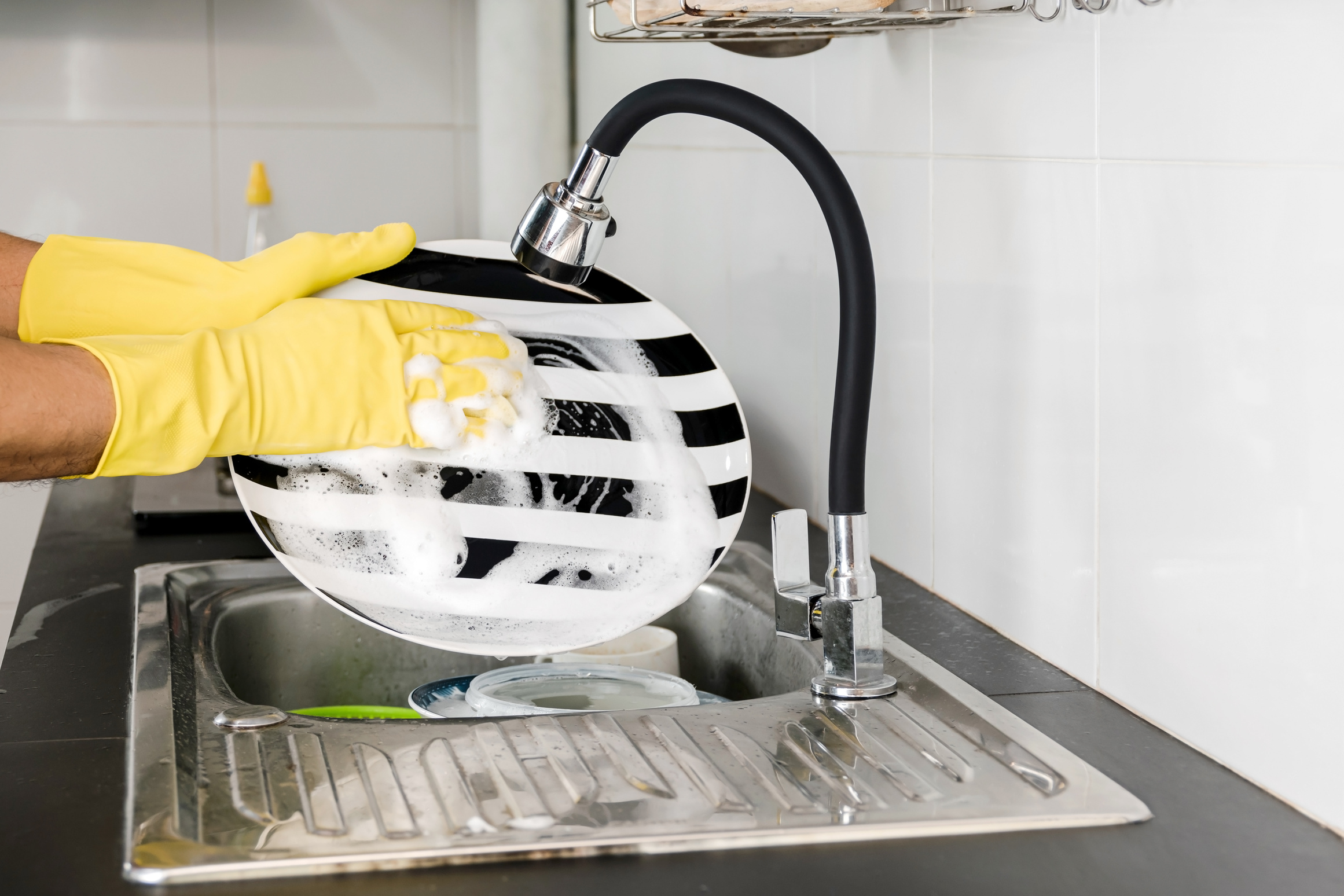 washing dishes in the kitchen sink.